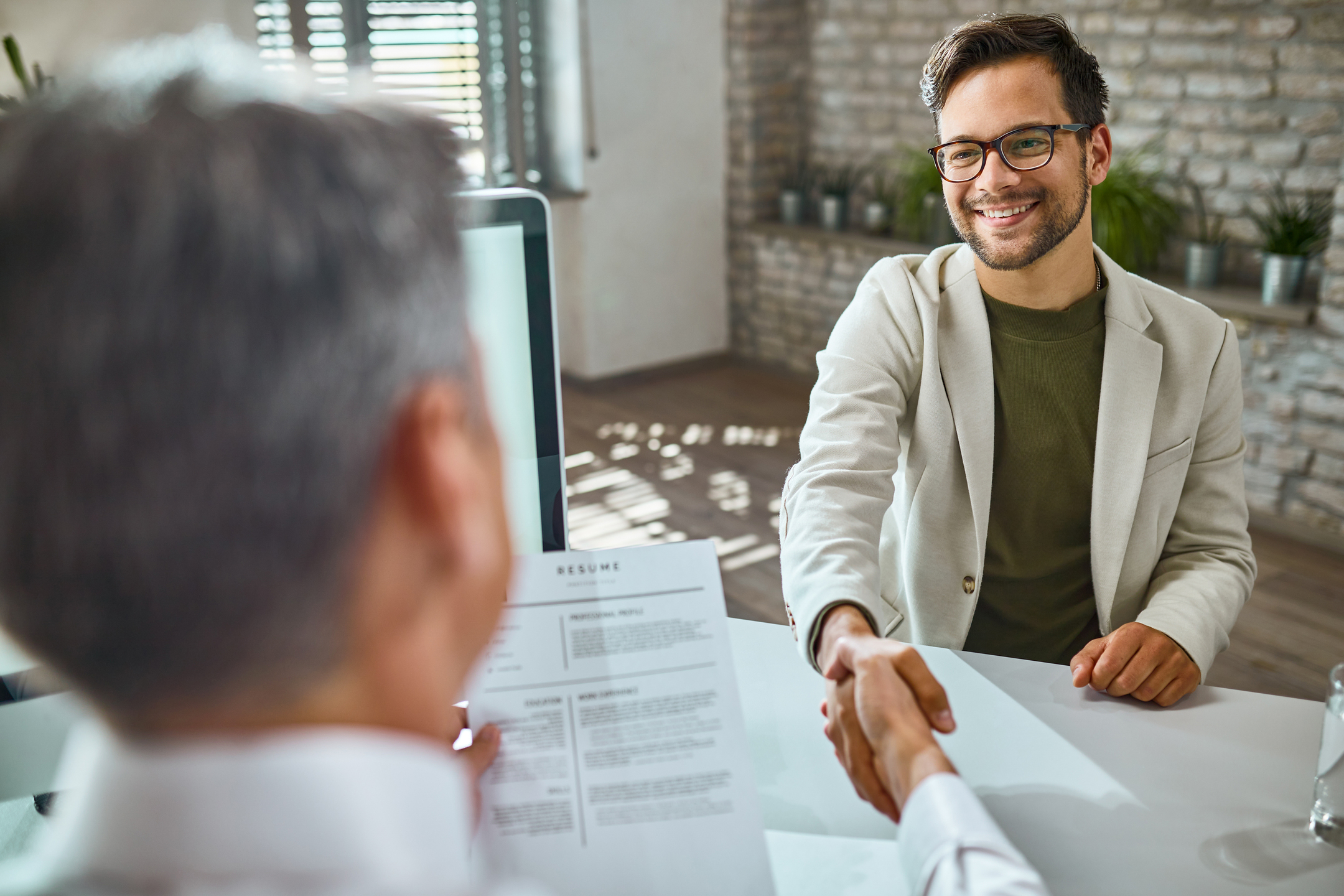 Happy-male-candidate-greeting-member-human-resource-team-job-interview-office